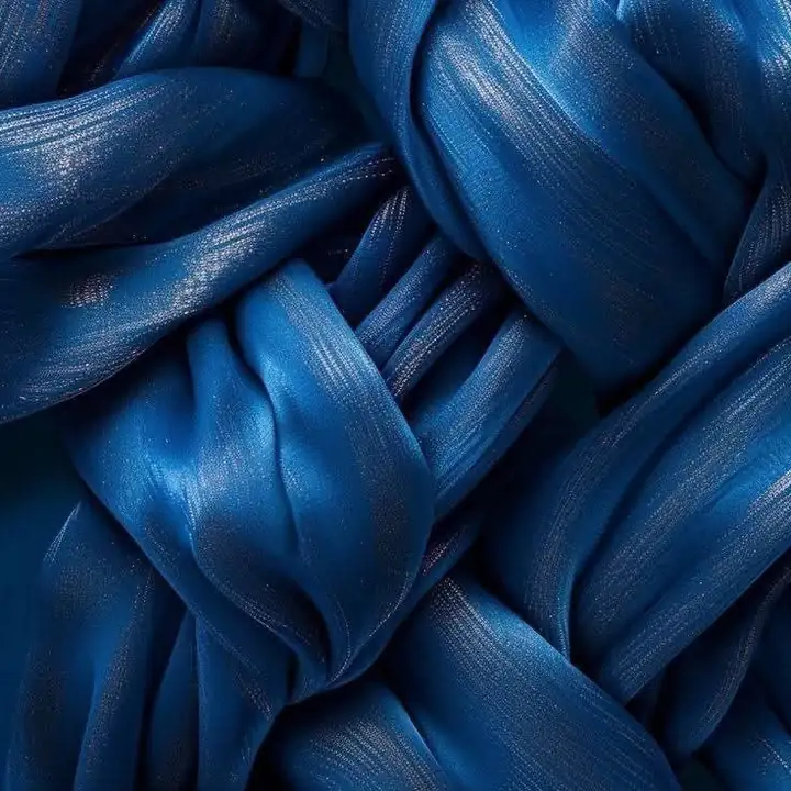 Twists of deep blue fabric folded over each other