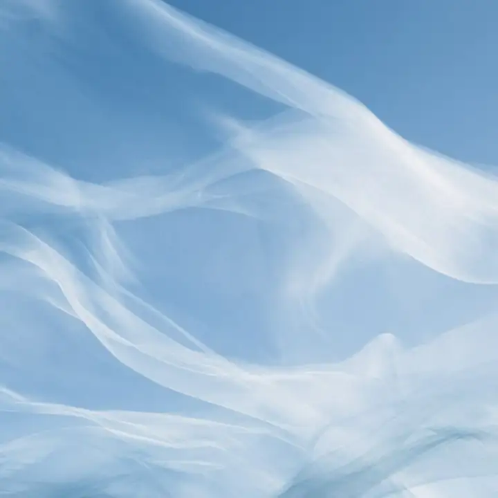 Soft white and blue fabric falling in loose folds