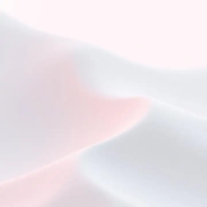 A fold of blush pink satin against off-white