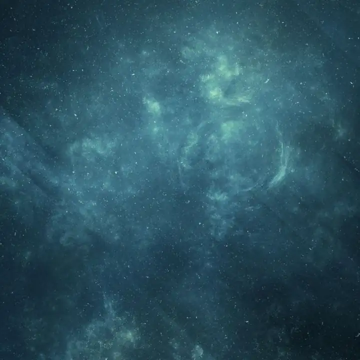 Clouds of teal light in near-black water