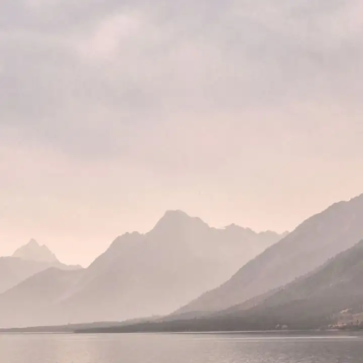 Layered mountains in dusty pink dawn light