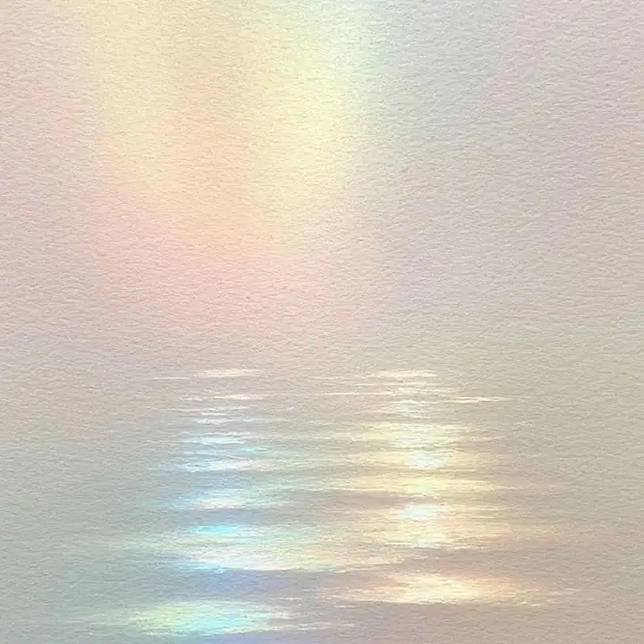 Rainbow light reflected on still shallow water
