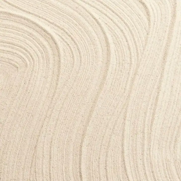 Raked lines drawn through fine pale sand