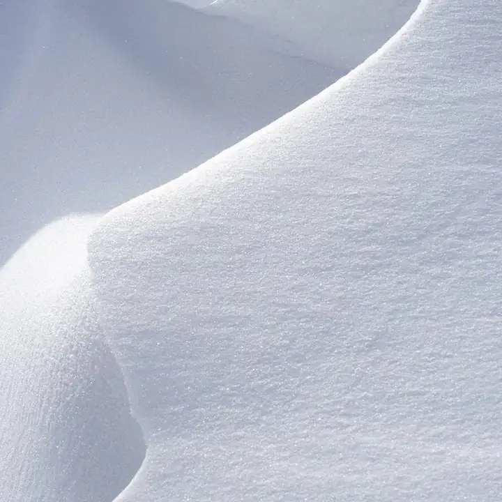 A smooth white snow slope with one soft edge