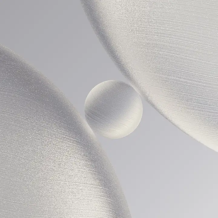 A single clear water drop resting on satin