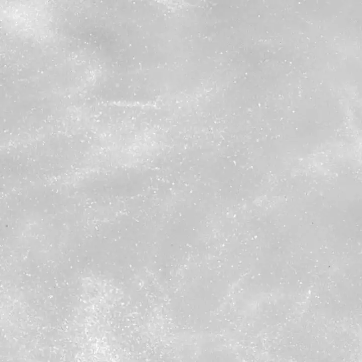 Fine frost grain across a white surface
